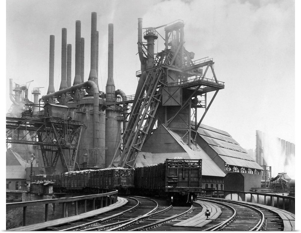 Pittsburgh, PA. Blast furnaces of the Carnegie Steel Corp. Photograph shows an exterior of Steel Plant with smokestakes an...