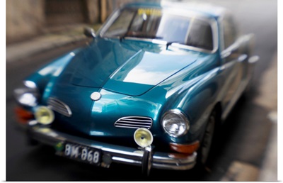 Blurred Motion Shot of a Metallic Blue Classic Car