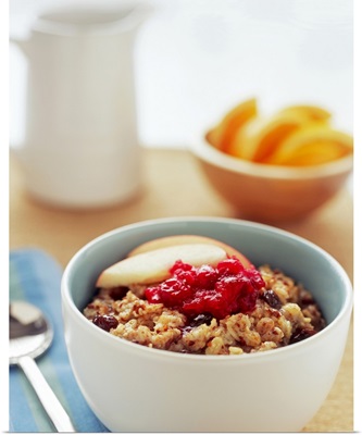 Bowl of raisin, oatmeal with apples and cranberries, close-up