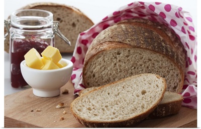Bread, butter and jam on chopping board