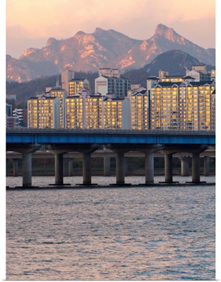 Buildings and Mount Bukhan by Han river in Seoul, South Korea.