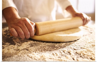 Chef rolling dough