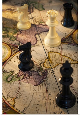 Chess pieces on old world map