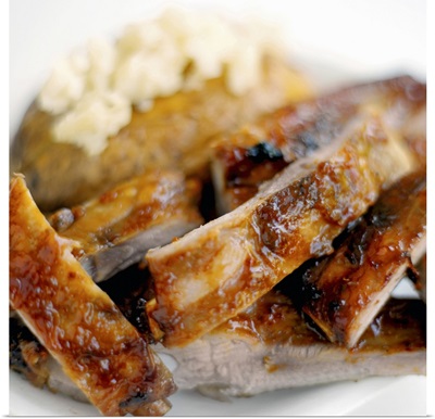 Close-up of a dish of mashed potato and spare ribs