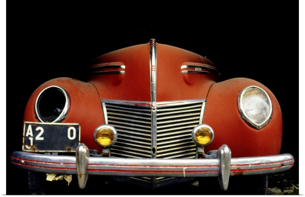 Close-up of a vintage car with a broken headlight
