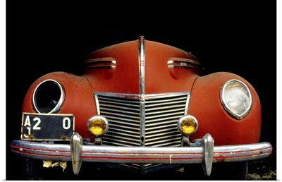 Close-up of a vintage car with a broken headlight