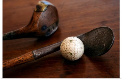 Close up of antique golf clubs and golf ball