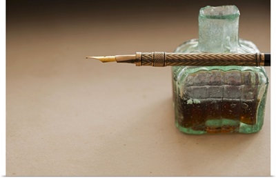 Close up of antique ink well and pen