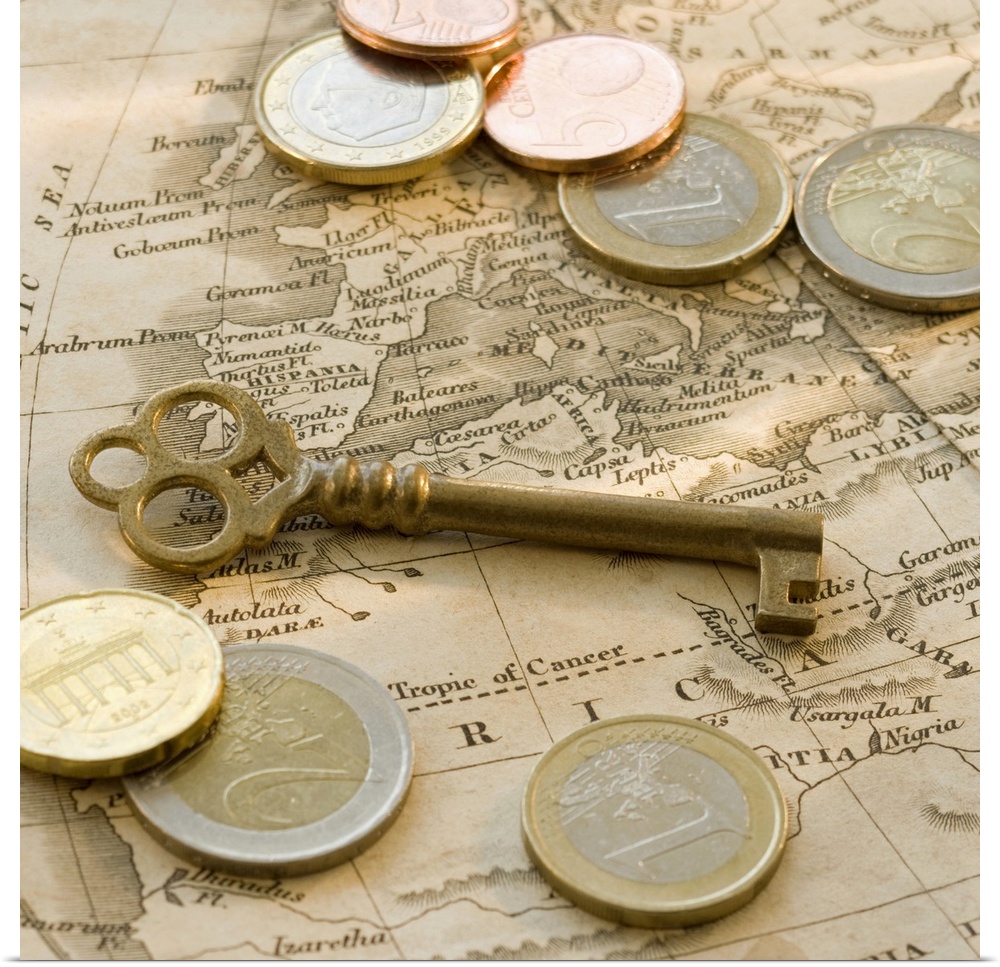 Close up of euro coins, map and antique key