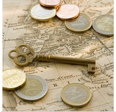 Close up of Euro coins, map and antique key