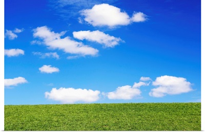 Clouds In Blue Sky Over Green Grass