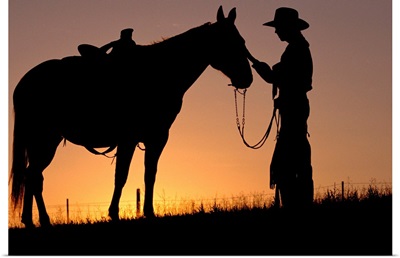 Cowboy Petting Horse At Sunset