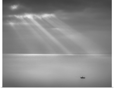 Crespecular rays over lone fishing boat in Bristol Channel off Brean Down, England, UK.