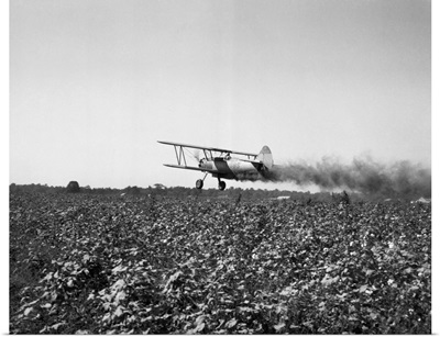 Crop Dusting Plane Flies Over Field