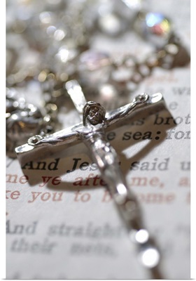 Crucifix on rosary with bible