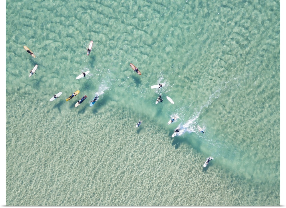 Crystal clear waters with surfers seen from above. Coastline of Australia.
