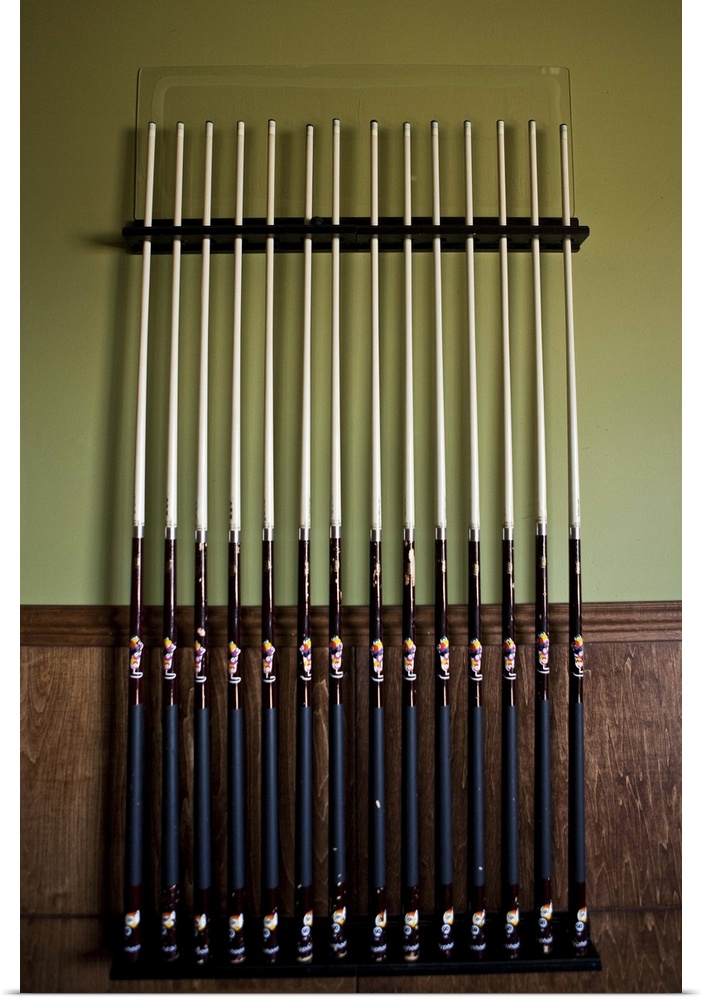 Cue sticks lined up against wall