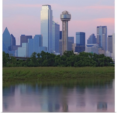 Dallas skyline reflected in water at sunset.