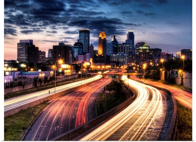 Downtown Minneapolis skyline and light trails on road