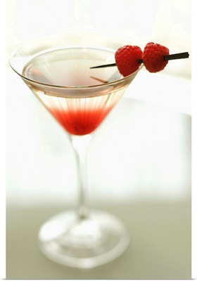 Drink in martini glass with raspberries