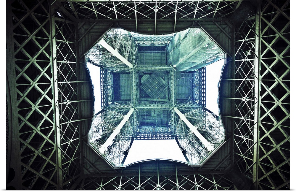 Horizontal photograph on a large canvas looking upward through the center of the Eiffel Tower in Paris.