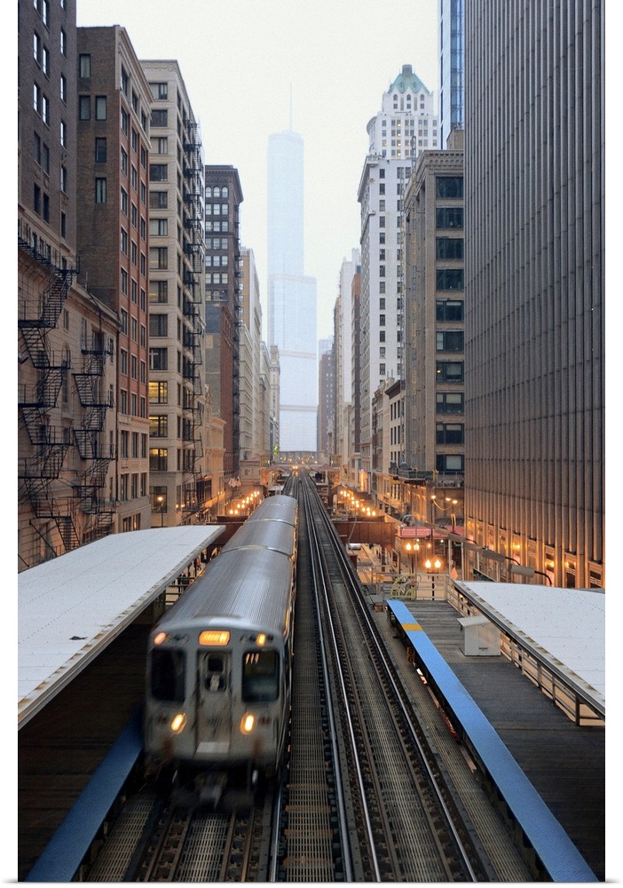 Vertical panoramic photograph of railway lined with tall buildings and skyscrapers.