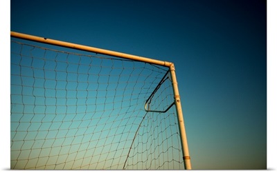 Football (Soccer) Goalpost and net against blue sky.