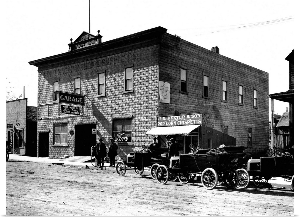 New model Fords are parked oustside the Dolloff building, housing a garage and Ford dealership, Minot, North Dakota, ca. 1...