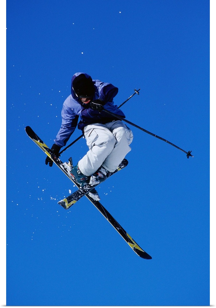 Free skier in mid-air jump, low angle view