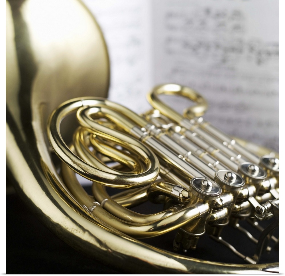 French horn in front of sheet music