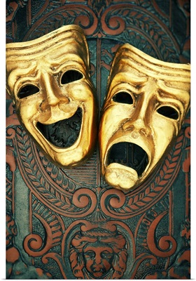 Golden comedy and tragedy masks on patterned leather
