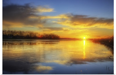 Golden sun reflection on lake in France.