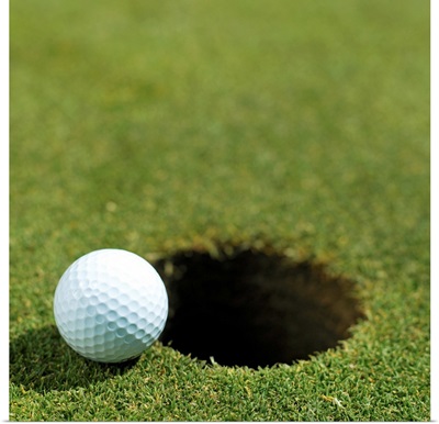 Golf ball on the edge of the hole
