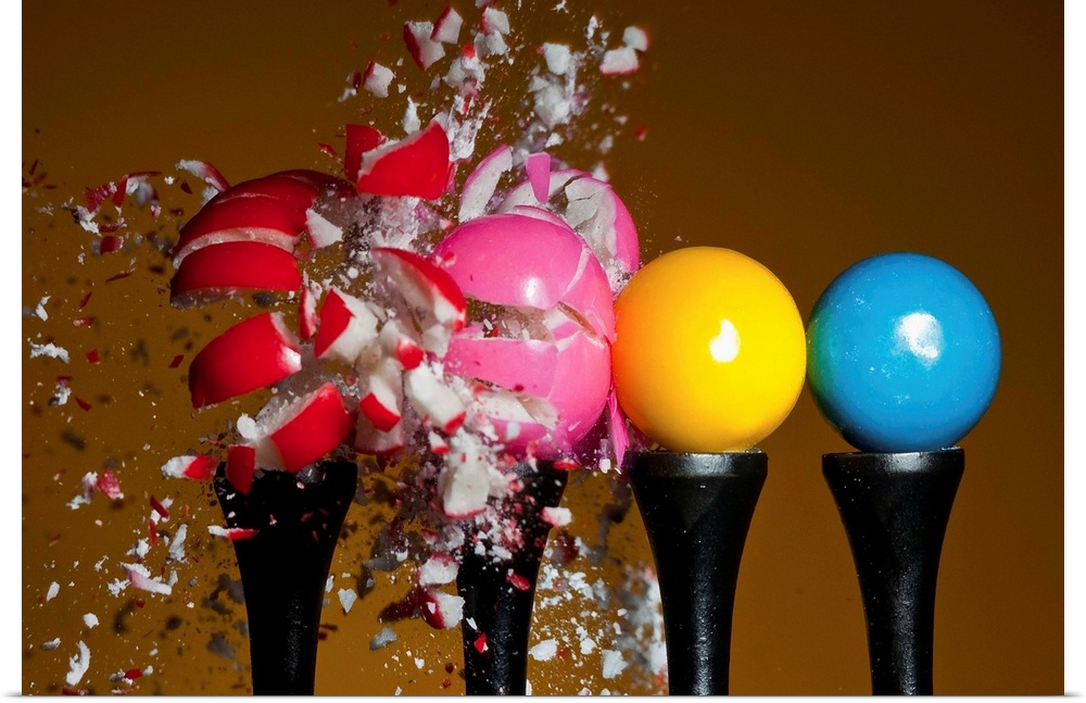 A row of candy gumballs are demolished by a pellet.
