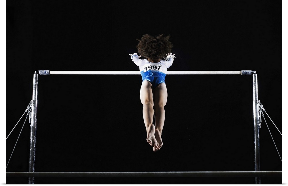 Gymnast (9-10) reaching for uneven bars