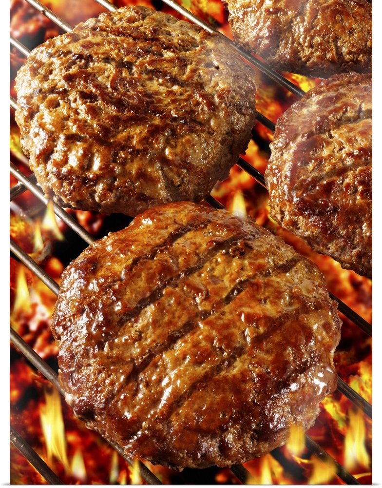 Burgers on barbecue rack, close up