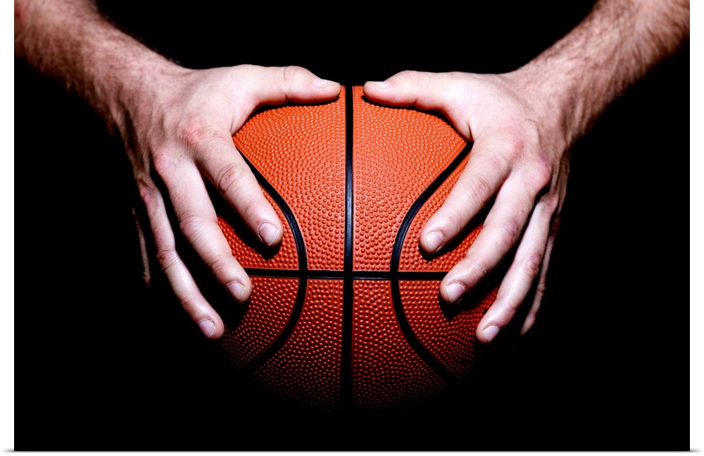 Hands holding a basketball