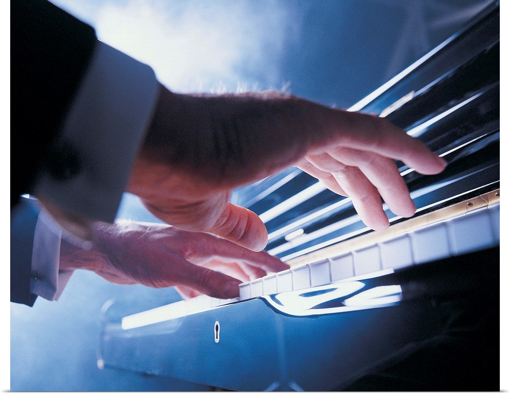 Hands playing piano keys