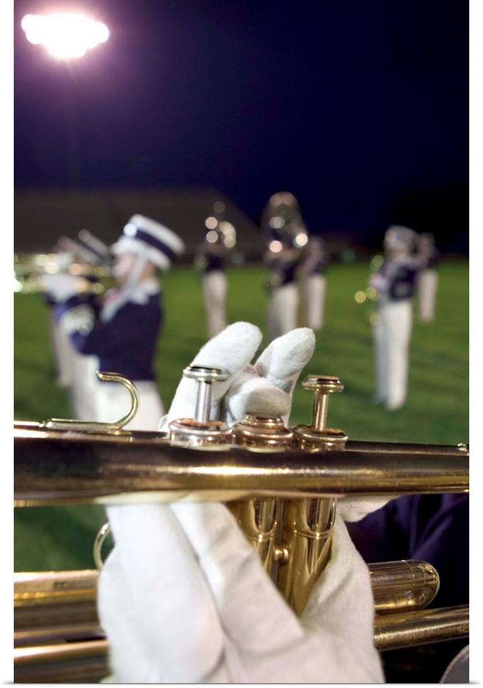 Hands playing trumpet in marching band