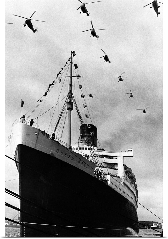 Royal Navy helicopters fly in formation over the Cunard liner Queen Mary as she leaves Southampton on the last voyage of h...