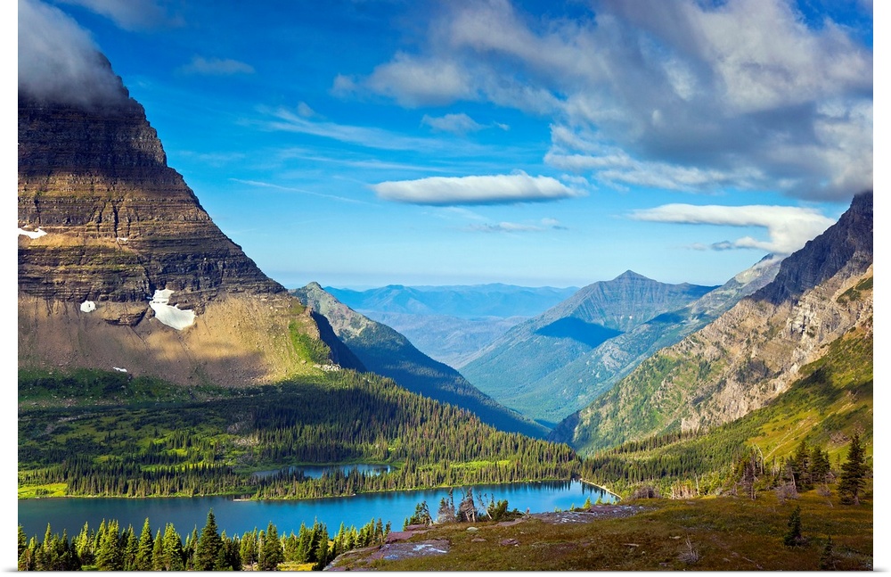 Large, landscape photograph of  Hidden Lake from an overlook, surrounded by mountains in Glacier National Park.