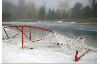 Hockey net left from season in melting snow at Ottawa, Ontario, Canada.