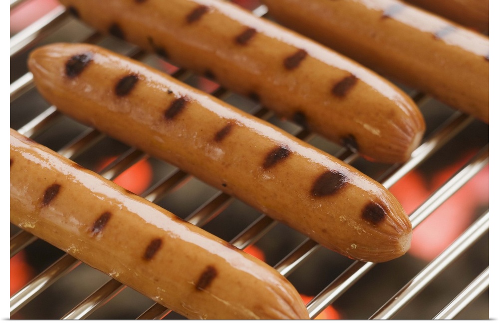 Hot dogs cooking on grill