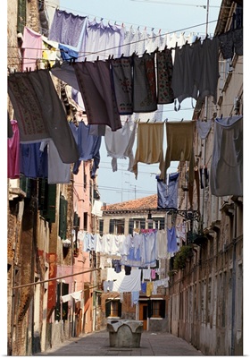 Italy, Venice, lines of washing hanging between buildings in sunny street