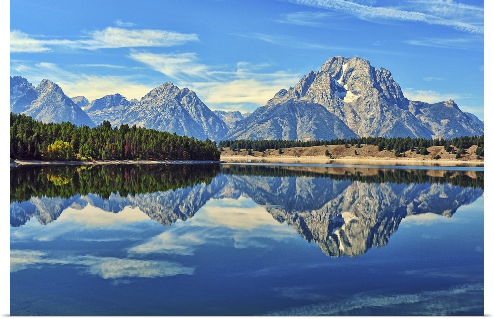 A reflection of Mount Moran and the Teton mountain range in the still waters of Jackson Lake in Grand Teton National Park,...