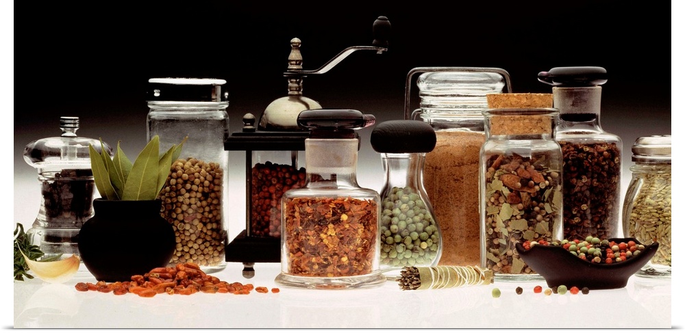 Landscape, large photograph of a variety of herbs and spices in numerous types of jars and grinders.