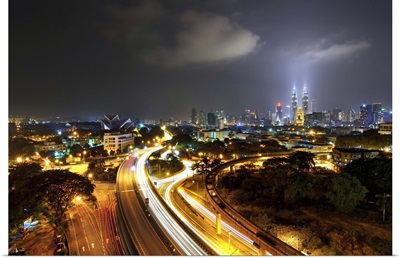Kuala Lumpur skyline and long exposure road at dusk.