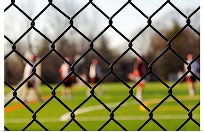 Lacrosse team behind a fence