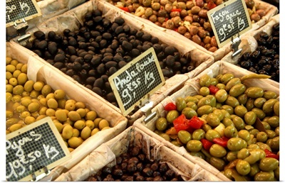 Large open boxes of black and green olives for sale in Market, France.