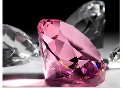 Large pink diamond surrounded by clear diamonds, close-up (still life)